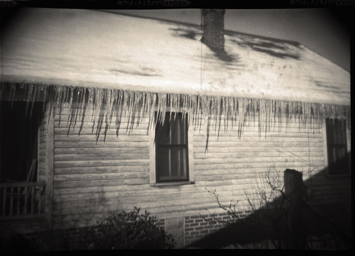 Photo of home with icicles hanging from roof in 1958