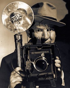 Photographer with Speed Graphic and fedora hat